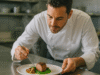 Chef plating a signature dish in a modern kitchen — Food & Beverage SEO.